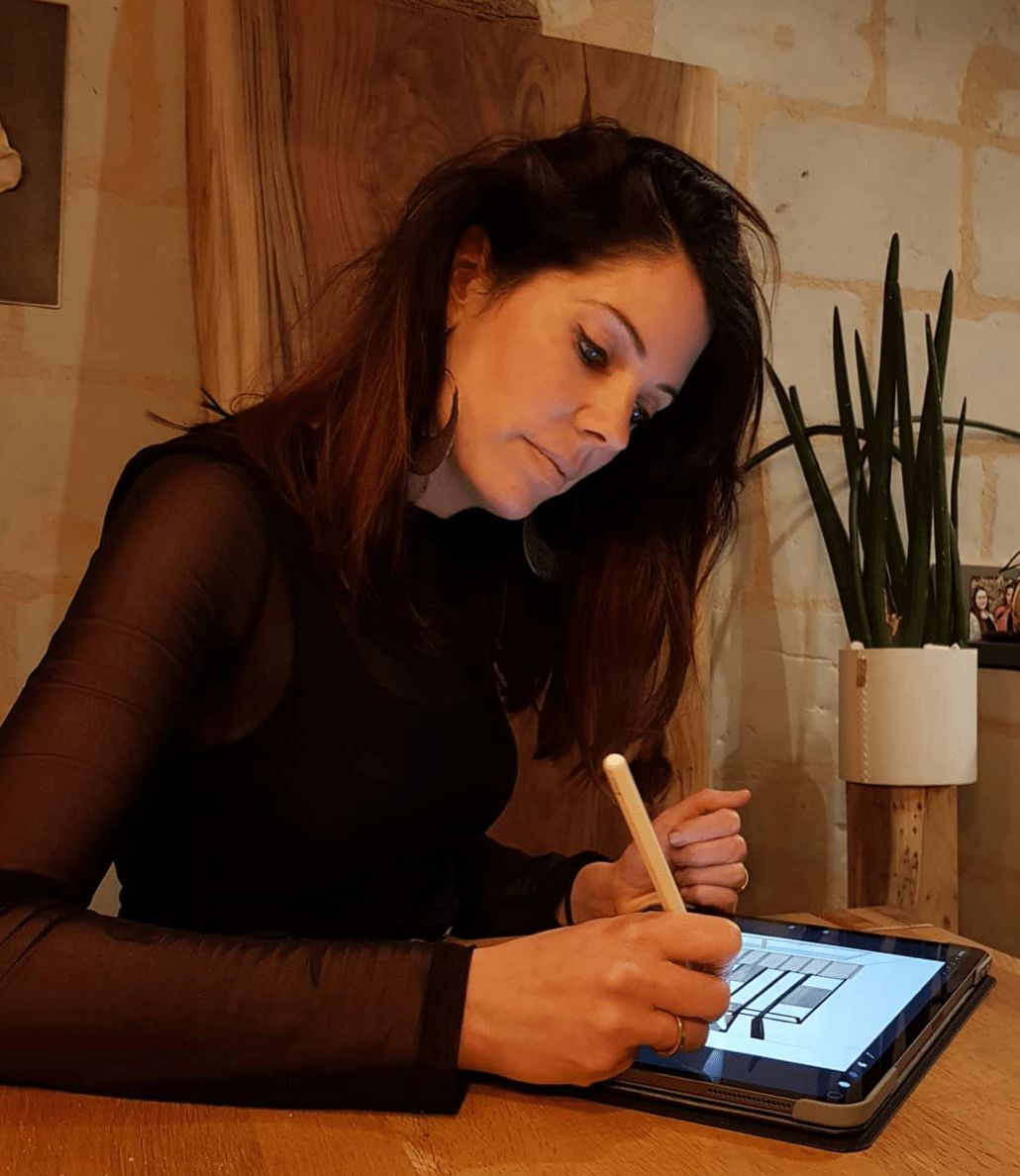 Cindy écrivant sur son iPad dans son atelier